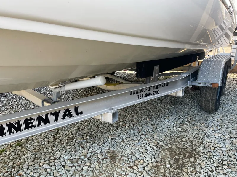 Slide: The Image of 2012 Stingray 225 LR boat on a Continental trailer, parked on gravel. - 8