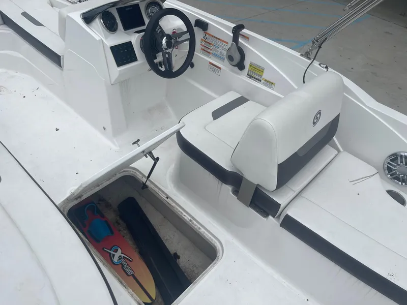 Slide: The Image of 2022 Hurricane SS185 OB boat interior with storage compartment and steering console. - 19