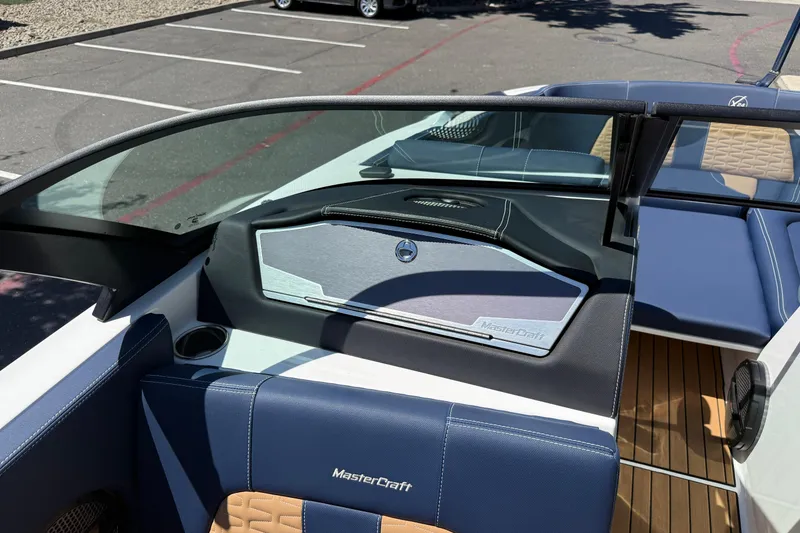 Slide: The Image of 2024 MasterCraft X24 boat interior with blue seating and sleek dashboard design. - 26