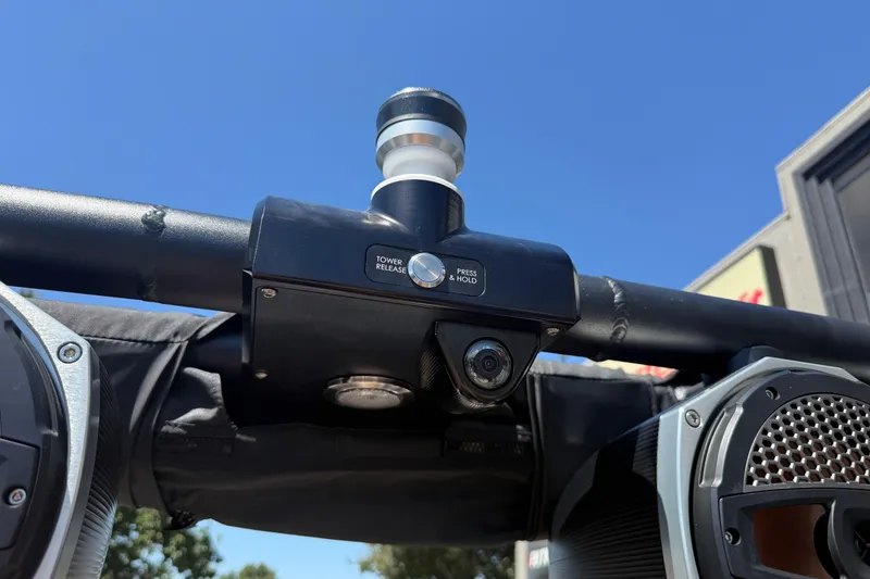 Slide: The Image of 2024 MasterCraft X24 tower release mechanism with camera and speakers under clear blue sky. - 33