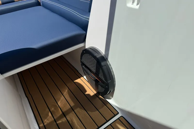 Slide: The Image of 2024 MasterCraft X24 boat interior with blue seating and teak flooring. - 34