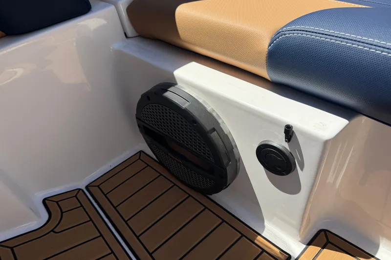 Slide: The Image of 2024 MasterCraft X24 boat interior with speaker and cushioned seating. - 35