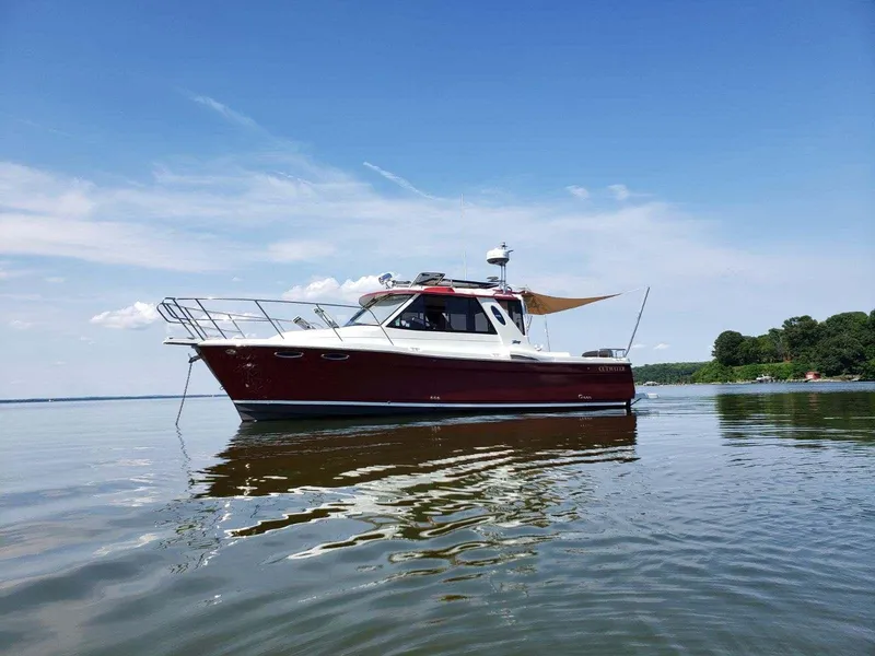 The Image of 2011 Cutwater 28 boat on calm water with clear blue sky. - 1