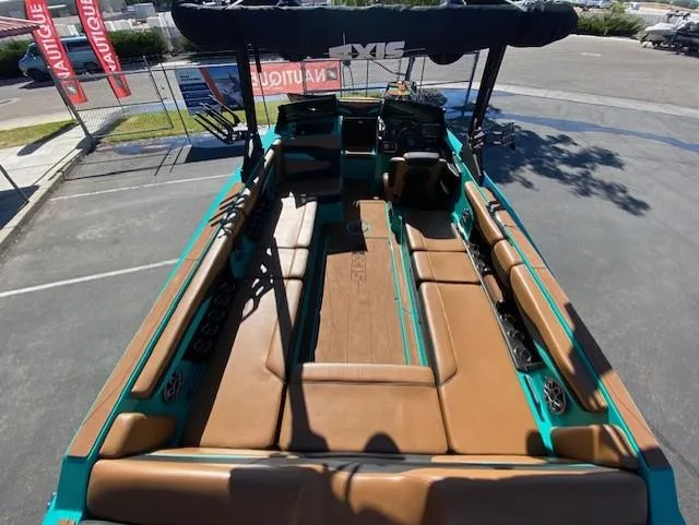 Slide: The Image of 2022 Axis Wake Research T250 boat interior with brown seating and teal accents. - 11