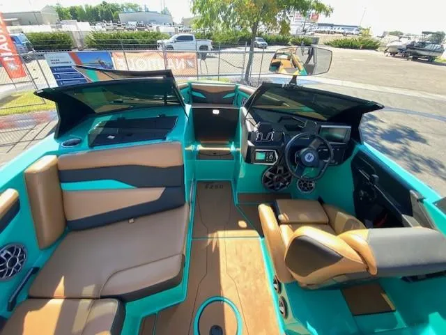Slide: The Image of 2022 Axis Wake Research T250 boat interior with teal and tan seating. - 13
