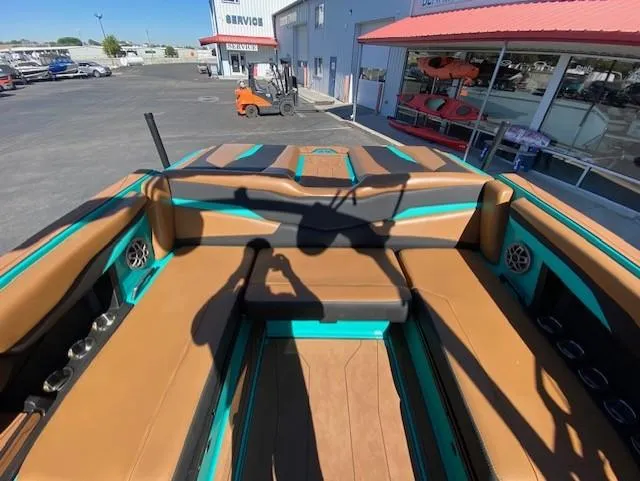 Slide: The Image of 2022 Axis Wake Research T250 boat interior with brown and teal seating. - 15