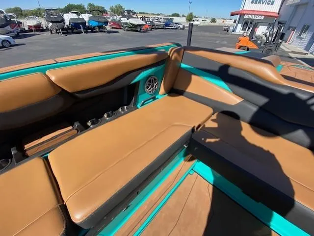 Slide: The Image of 2022 Axis Wake Research T250 boat interior with tan and teal seating. - 16