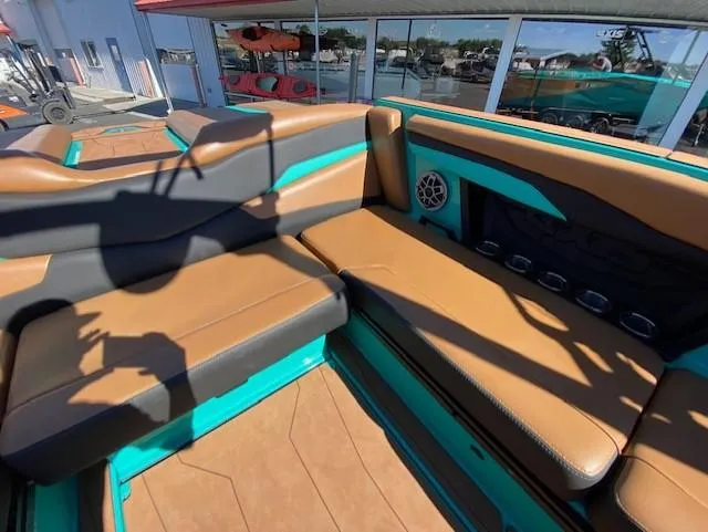 Slide: The Image of 2022 Axis Wake Research T250 boat interior with brown and teal seating. - 17