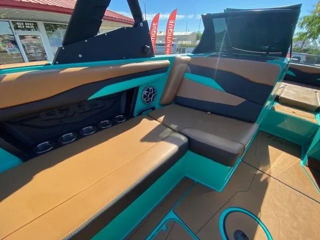 Slide: The Image of 2022 Axis Wake Research T250 boat interior with tan and teal seating. - 18