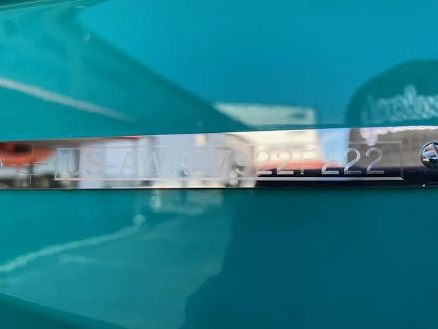 Slide: The Image of 2022 Axis Wake Research T250 boat identification number on teal surface. - 22