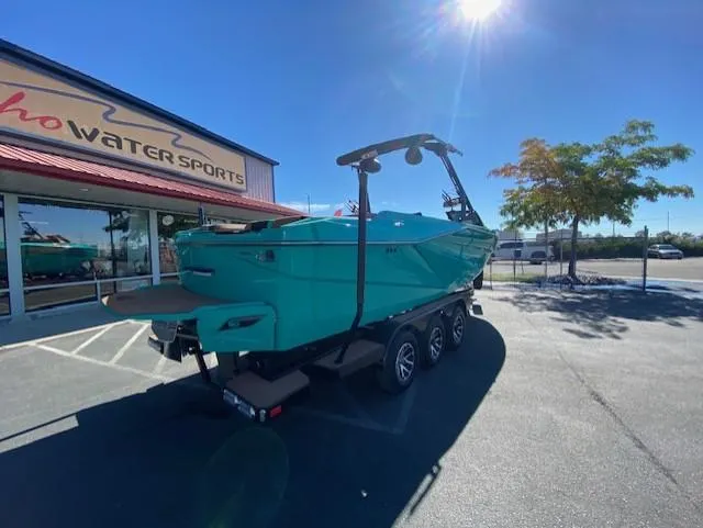 Slide: The Image of 2022 Axis Wake Research T250 boat on trailer outside water sports store. - 3