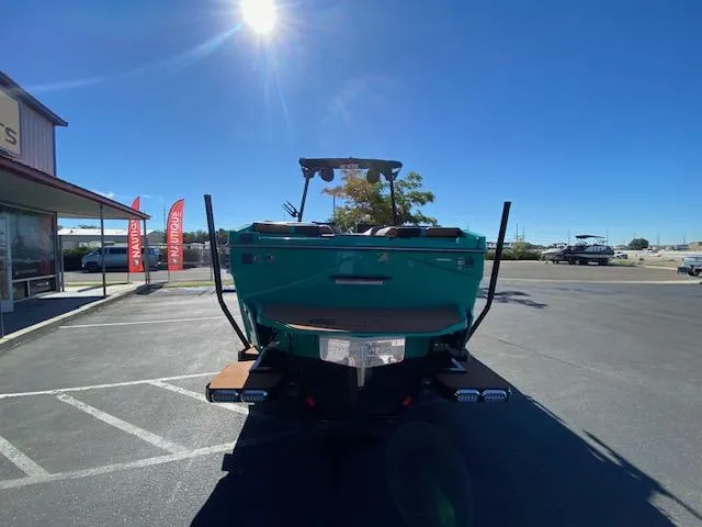 Slide: The Image of 2022 Axis Wake Research T250 boat in parking lot under clear blue sky. - 4