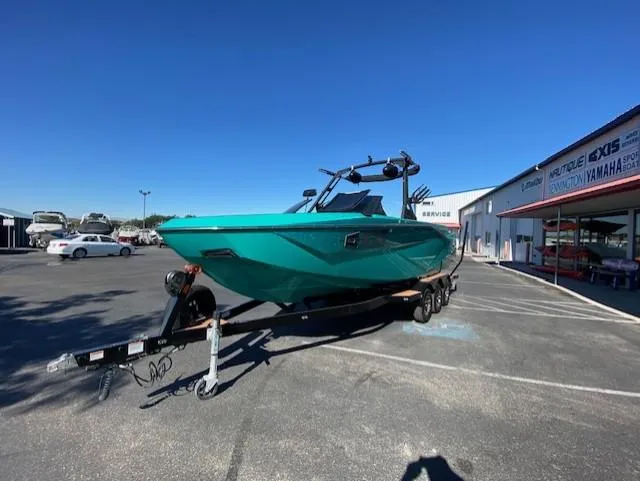 Slide: The Image of 2022 Axis Wake Research T250 boat on trailer in dealership parking lot. - 7