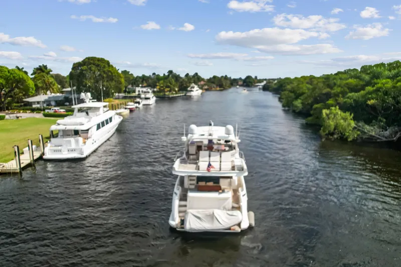 Slide: The Image of Luxury 2013 Azimut 70 yacht cruising a scenic river with lush greenery. - 24