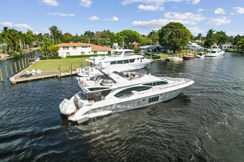 Slide: The Image of 2013 Azimut 70 yacht cruising in a scenic waterfront neighborhood. - 25