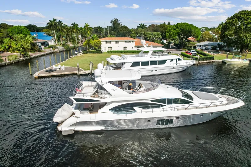 Slide: The Image of 2013 Azimut 70 yacht docked in a scenic marina. - 26