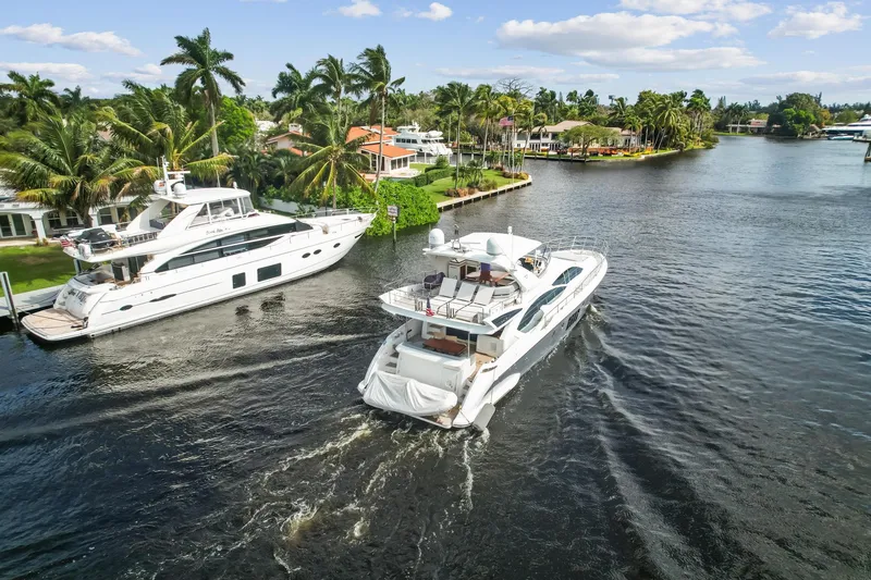 Slide: The Image of 2013 Azimut 70 yacht cruising in a scenic waterfront neighborhood. - 31