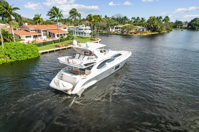 Slide: The Image of 2013 Azimut 70 yacht cruising in a scenic waterfront neighborhood. - 32