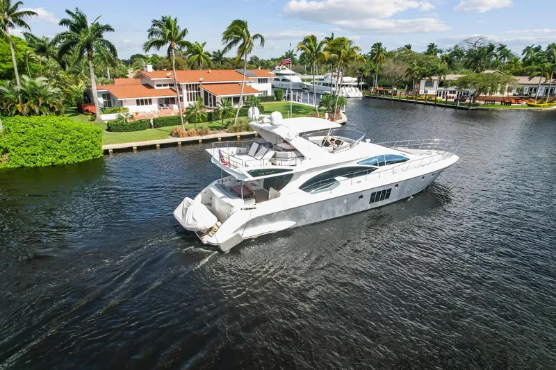 Slide: The Image of 2013 Azimut 70 yacht cruising near waterfront homes with palm trees. - 33