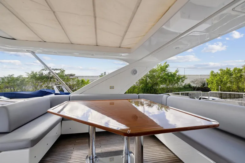 Slide: The Image of Luxurious seating area on a 2013 Azimut 70 yacht with a polished wooden table. - 35