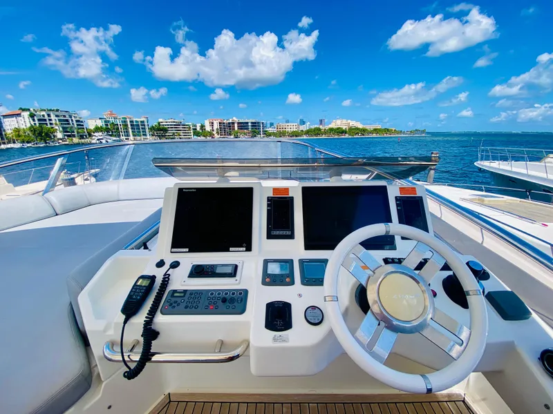 Slide: The Image of Cockpit view of 2013 Azimut 70 yacht with ocean and cityscape background. - 40