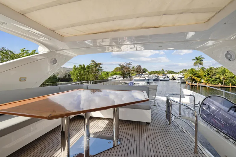 Slide: The Image of Spacious deck of 2013 Azimut 70 yacht with wooden table and waterfront view. - 41