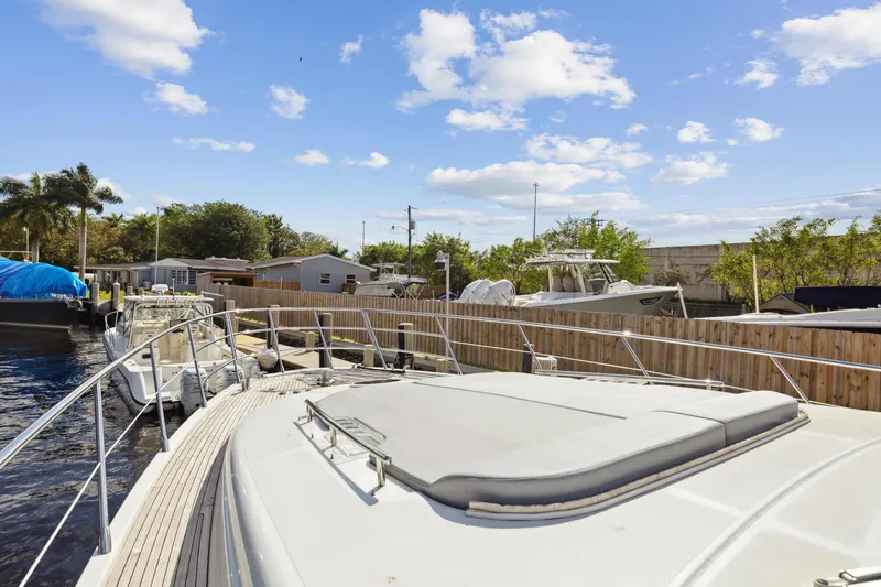Slide: The Image of 2013 Azimut 70 yacht docked at a marina under a clear blue sky. - 48