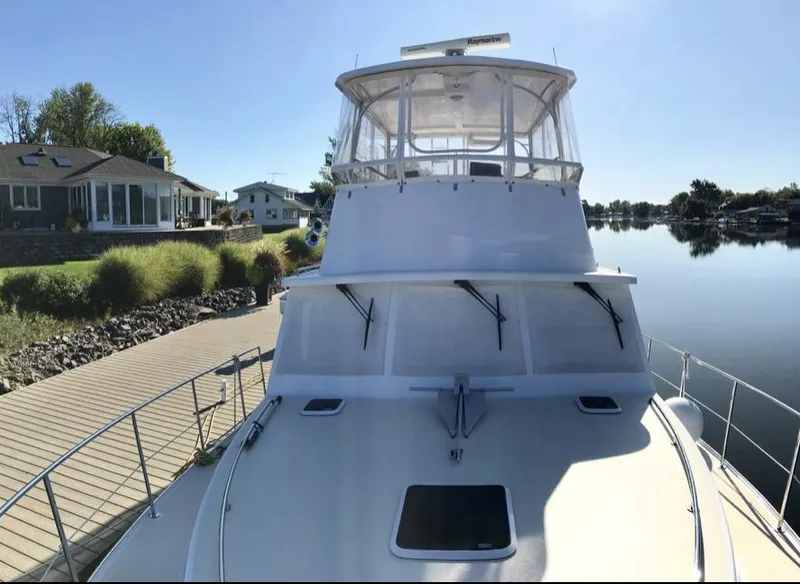 Slide: The Image of 2007 Duffy Aft Cabin boat docked by a serene waterfront home. - 10