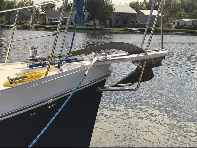 Slide: The Image of 2007 Duffy Aft Cabin boat anchored on a calm lake with nearby houses. - 13