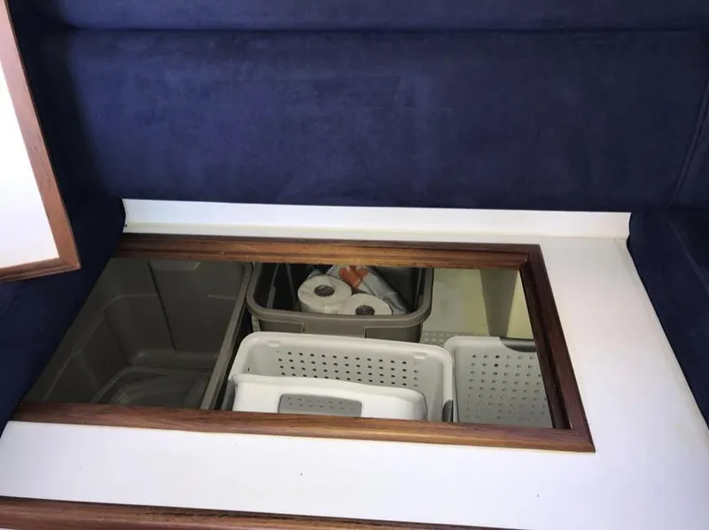 Slide: The Image of Storage compartment in 2007 Duffy Aft Cabin with organized bins and supplies. - 25