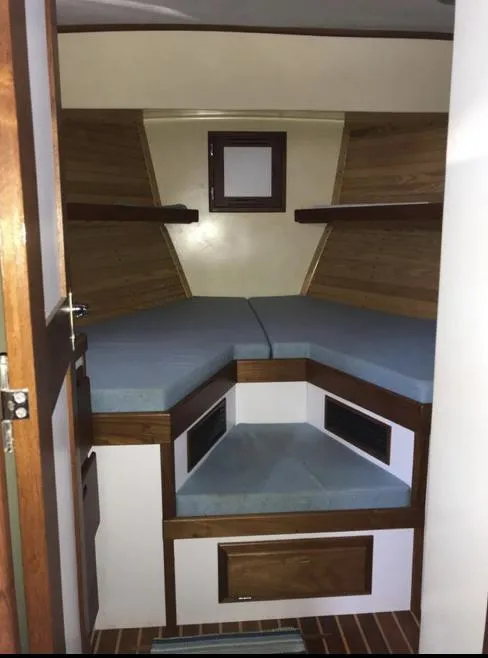 Slide: The Image of 2007 Duffy Aft Cabin interior with wooden accents and blue cushions. - 27