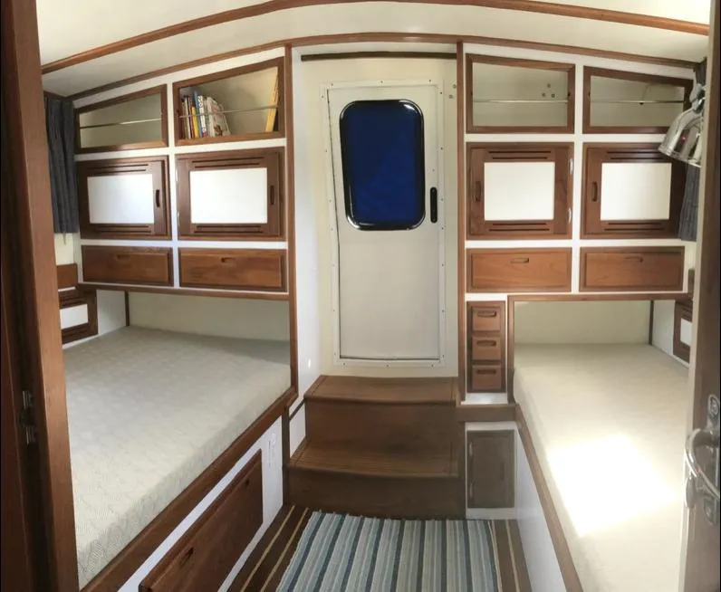 Slide: The Image of 2007 Duffy Aft Cabin interior with wooden cabinetry and twin beds. - 33