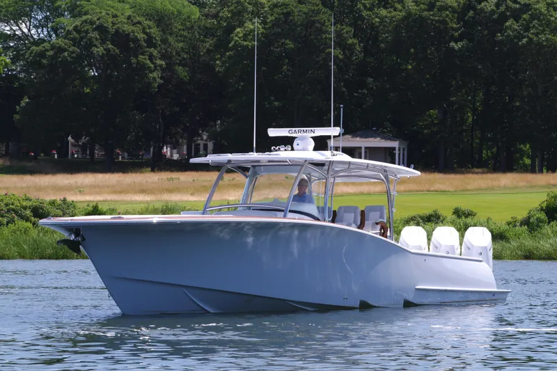 Slide: The Image of 2025 Mag Bay 43 CC boat cruising on a serene lake. - 1