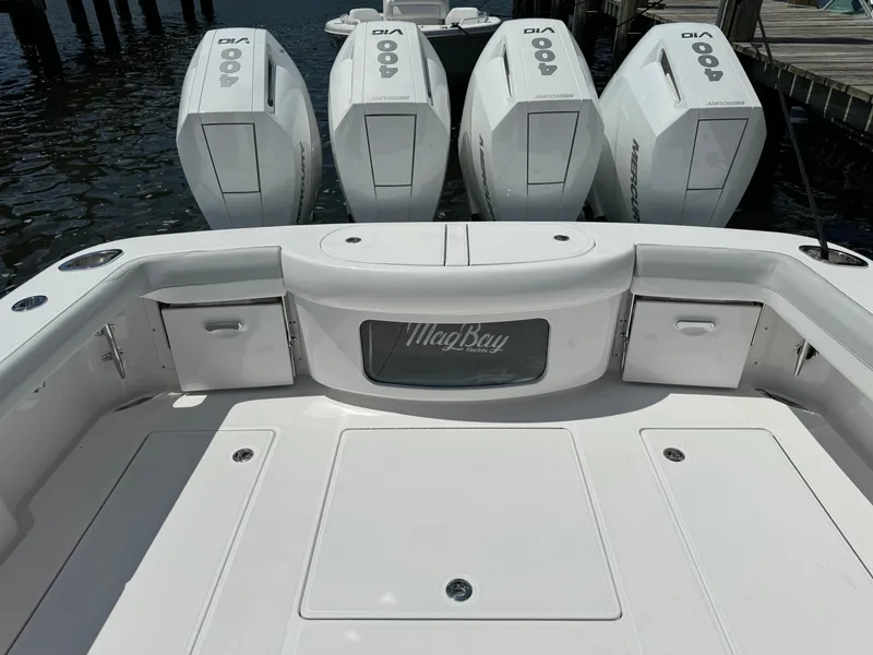Slide: The Image of 2025 Mag Bay 43 CC boat with quad outboard engines at dock. - 24