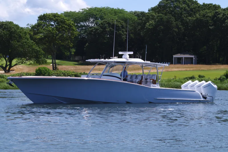 Slide: The Image of 2025 Mag Bay 43 CC boat cruising on a serene lake. - 3