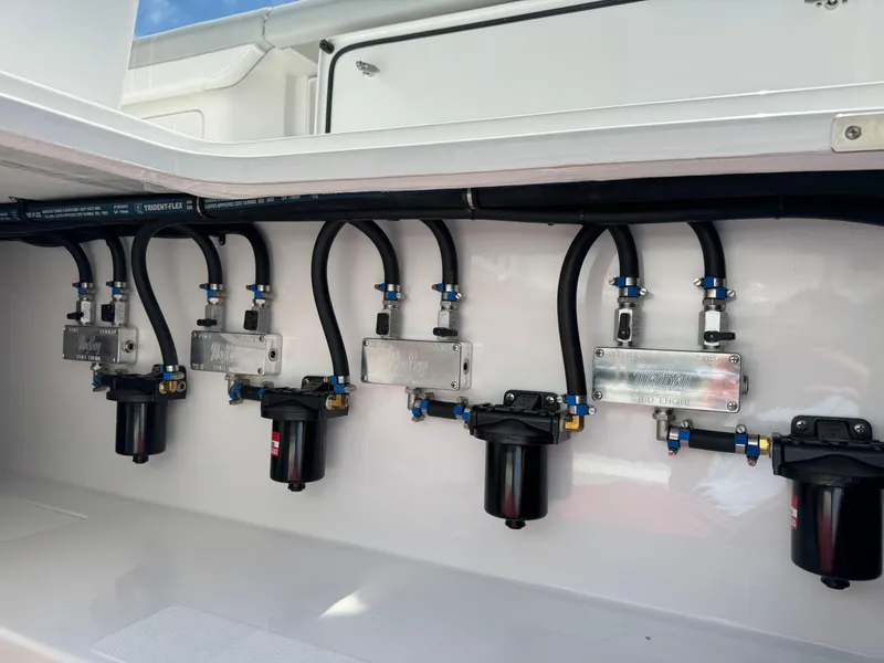 Slide: The Image of 2025 Mag Bay 43 CC boat engine compartment with fuel filters and hoses. - 31