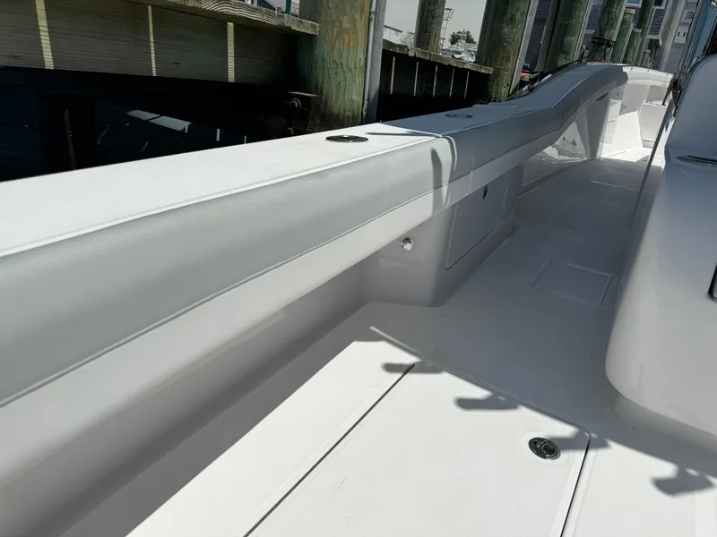 Slide: The Image of 2025 Mag Bay 43 CC boat deck with sleek design and storage compartments. - 32