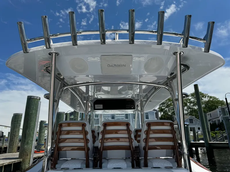 Slide: The Image of 2025 Mag Bay 43 CC boat with rod holders and seating at the dock. - 36