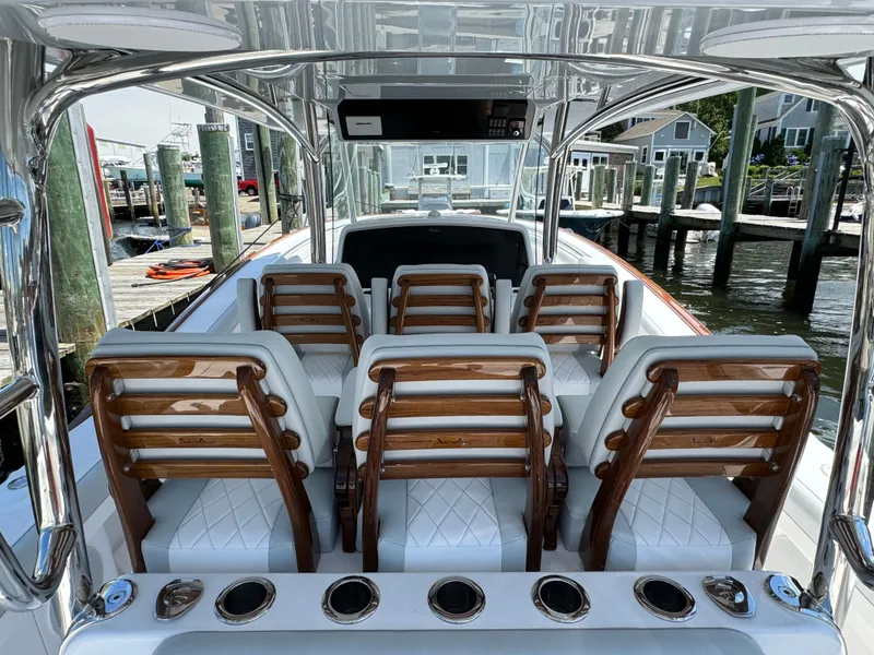 Slide: The Image of 2025 Mag Bay 43 CC boat interior with luxurious seating and rod holders. - 38