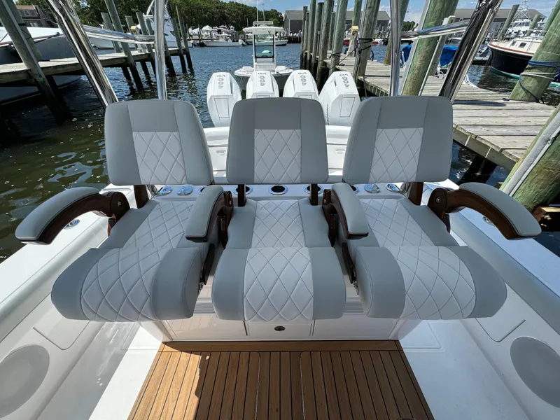 Slide: The Image of Luxury seating on the 2025 Mag Bay 43 CC boat at a marina. - 42
