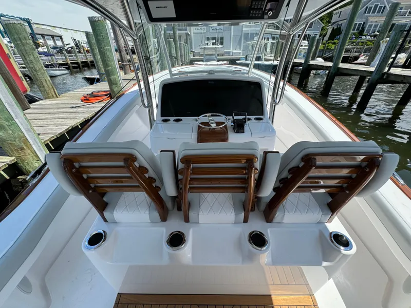 Slide: The Image of 2025 Mag Bay 43 CC boat cockpit with helm station and seating. - 43