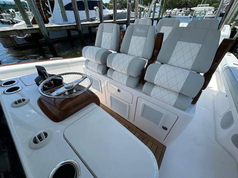 Slide: The Image of 2025 Mag Bay 43 CC boat interior with luxurious seating and steering console. - 45