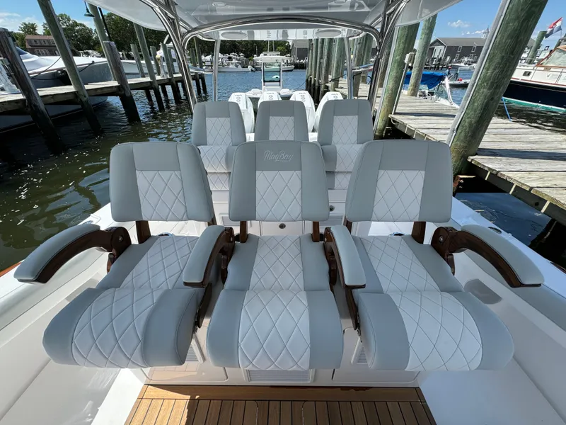 Slide: The Image of Luxurious seating on the 2025 Mag Bay 43 CC boat at a marina. - 47