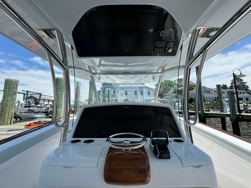 Slide: The Image of 2025 Mag Bay 43 CC boat helm station with modern controls and waterfront view. - 49
