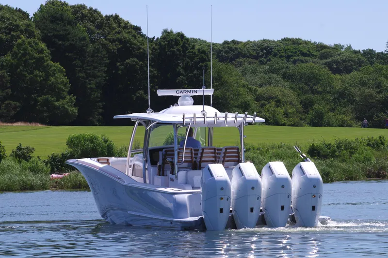 Slide: The Image of 2025 Mag Bay 43 CC boat with four outboard engines on a lake. - 6