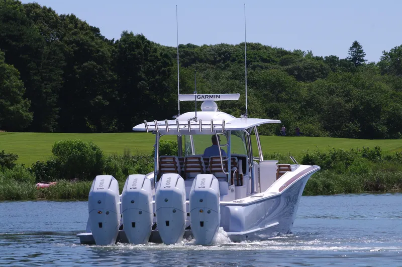 Slide: The Image of 2025 Mag Bay 43 CC boat with four outboard engines on a lake. - 8