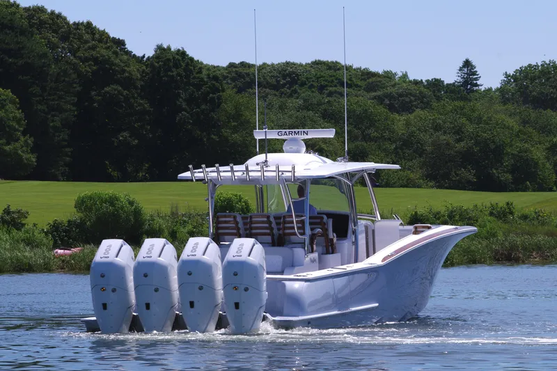 Slide: The Image of 2025 Mag Bay 43 CC boat with four outboard engines on a lake. - 9