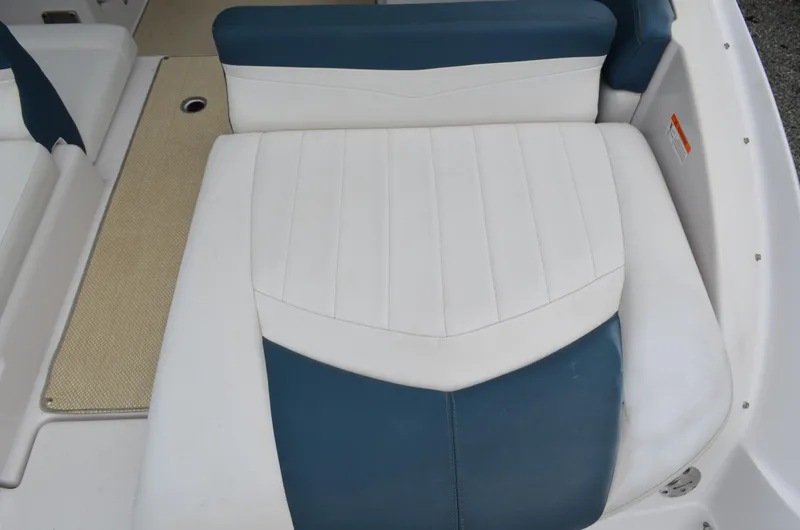Slide: The Image of 2013 Four Winns H310 boat interior seating with white and blue upholstery. - 17