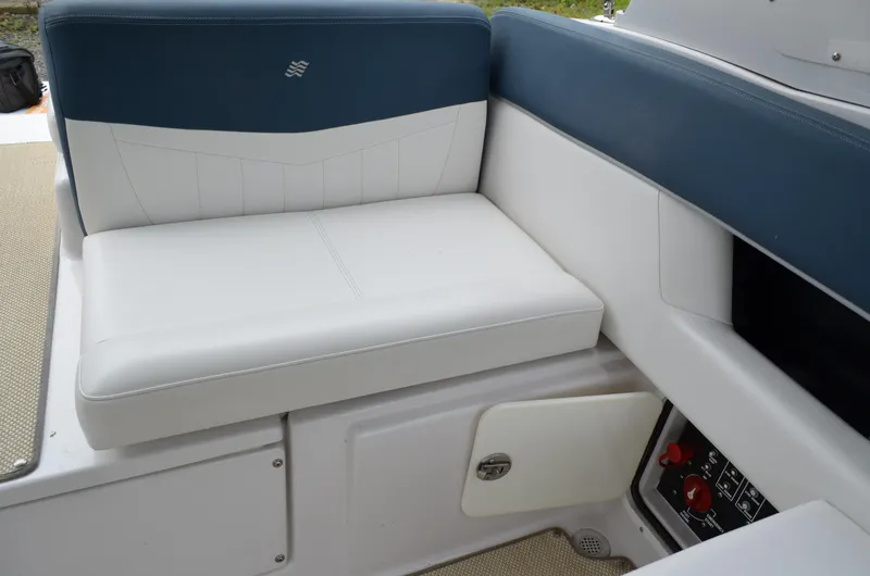 Slide: The Image of 2013 Four Winns H310 boat seating area with storage compartment. - 20