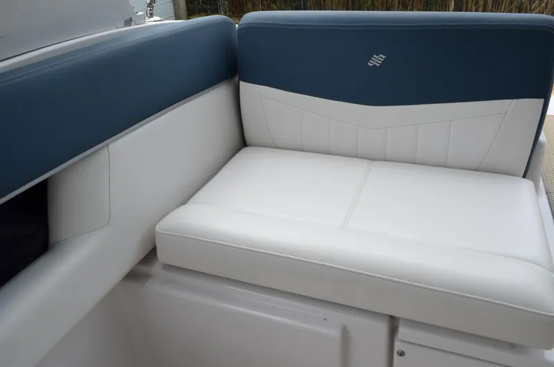 Slide: The Image of 2013 Four Winns H310 boat interior seating with blue and white upholstery. - 21